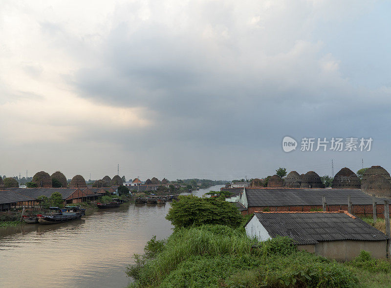 夕阳落在Mang Thit砖窑上，这是一个在越南永隆省Co Chien河边制砖和盖房子的村庄